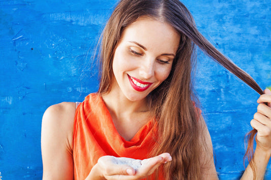 woman with dry shampoo in hand