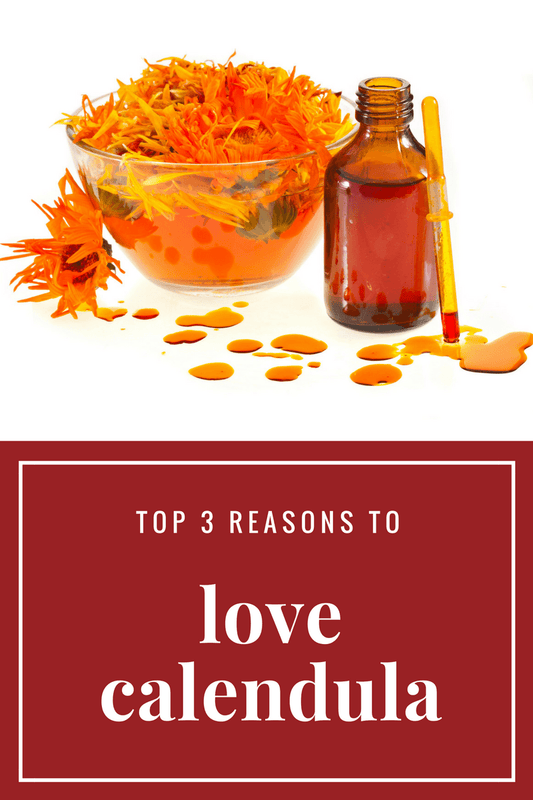 Calendula Oil in amber bottle with calendula flowers