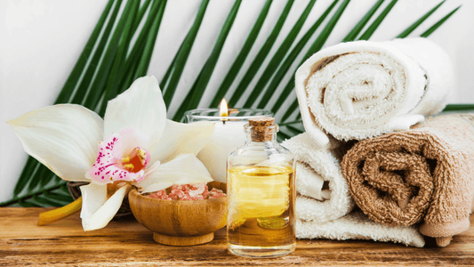 Picture of spa towels, flowers, candle, green leaves