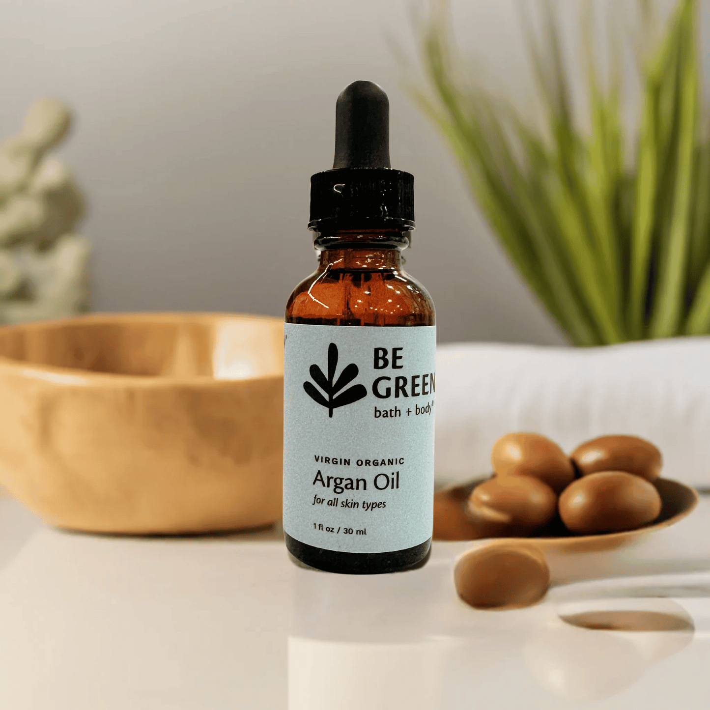 Bottle of Be Green argan oil with a dropper on a neutral background