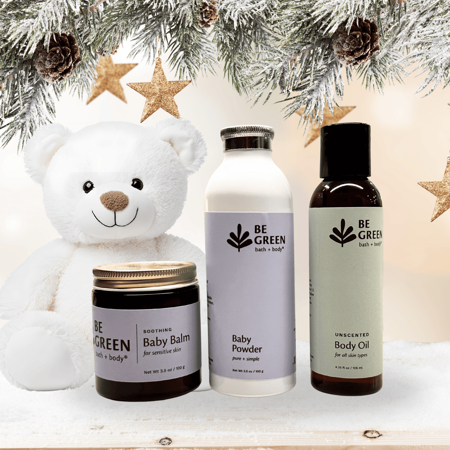 Be Green baby and body care products with a teddy bear and Christmas decorations.
