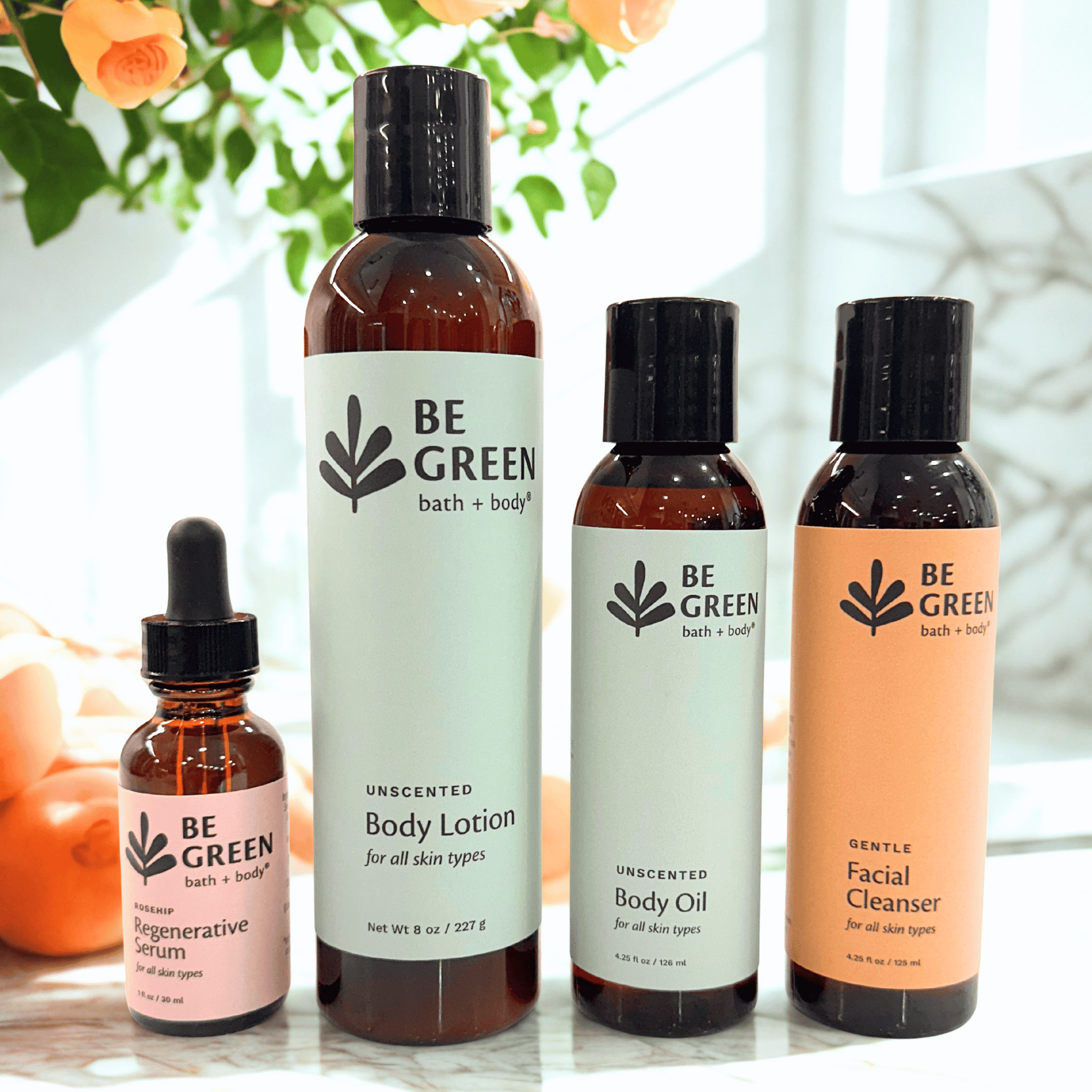 Set of 'Be Green' bath and body products on a light surface with a blurred natural background.