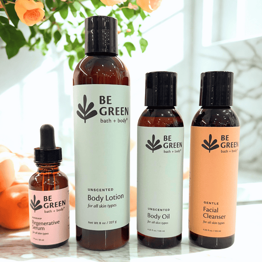 Set of 'Be Green' bath and body products on a light surface with a blurred natural background.