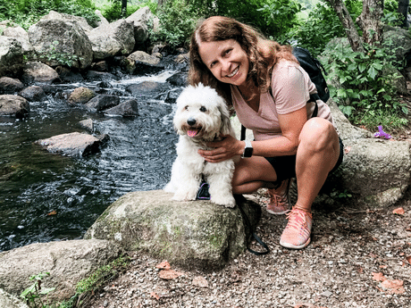 Picture of founder Karen Roche and her white dog, a Coton de Tulerar named Ruby.