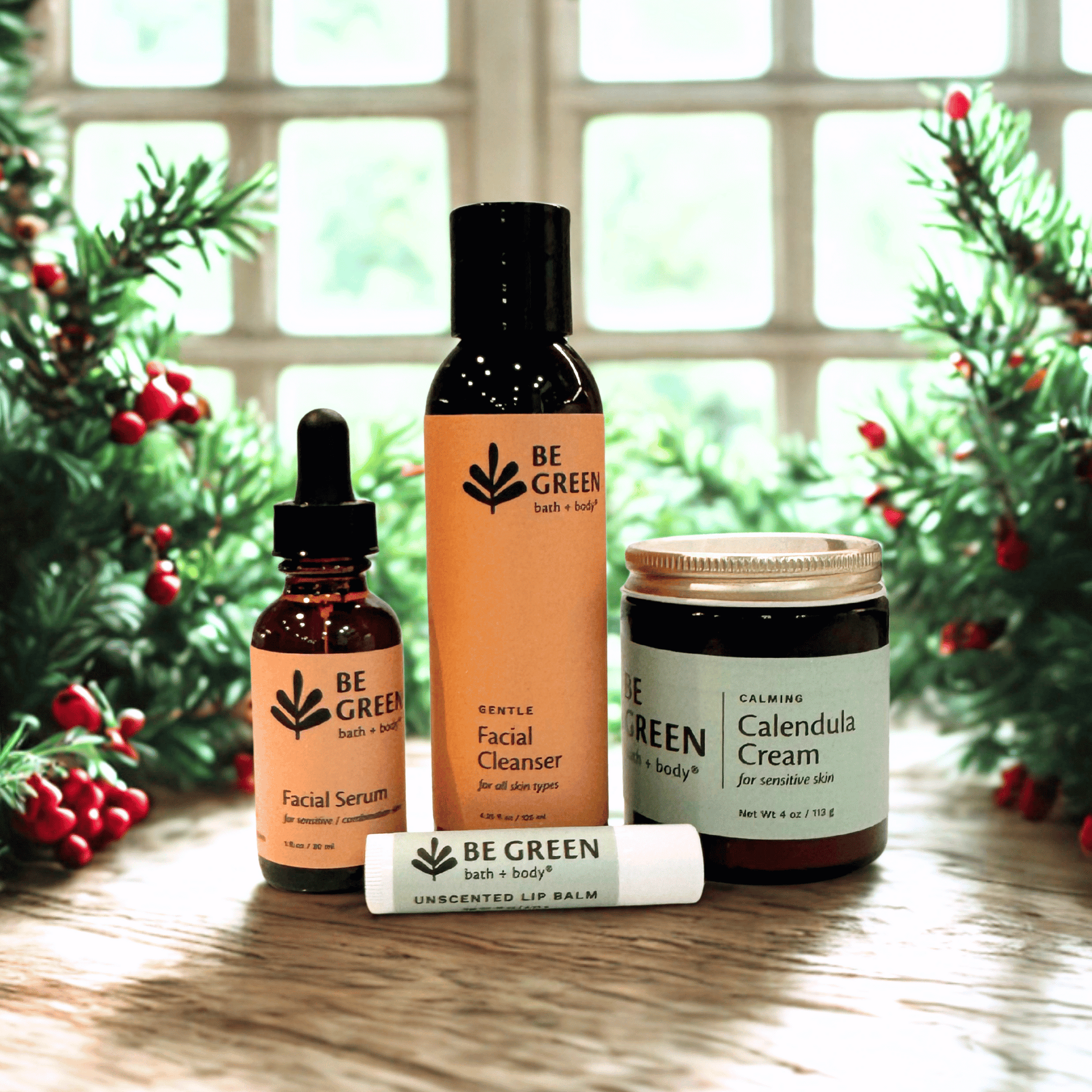 Set of 'Be Green' sensitive skincare products with Christmas trees in the background