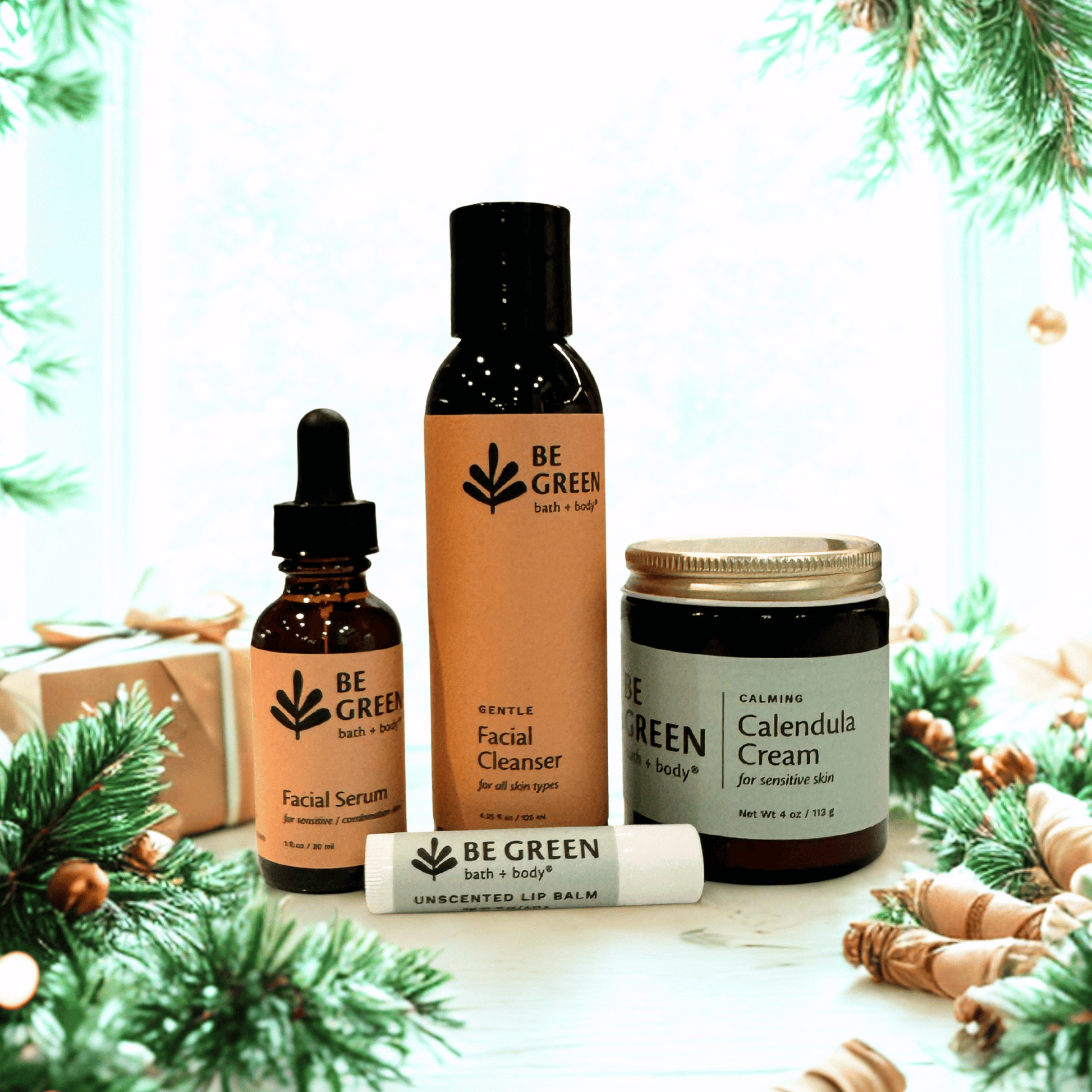 Collection of 'Be Green' skincare products with Christmas decorations in the background