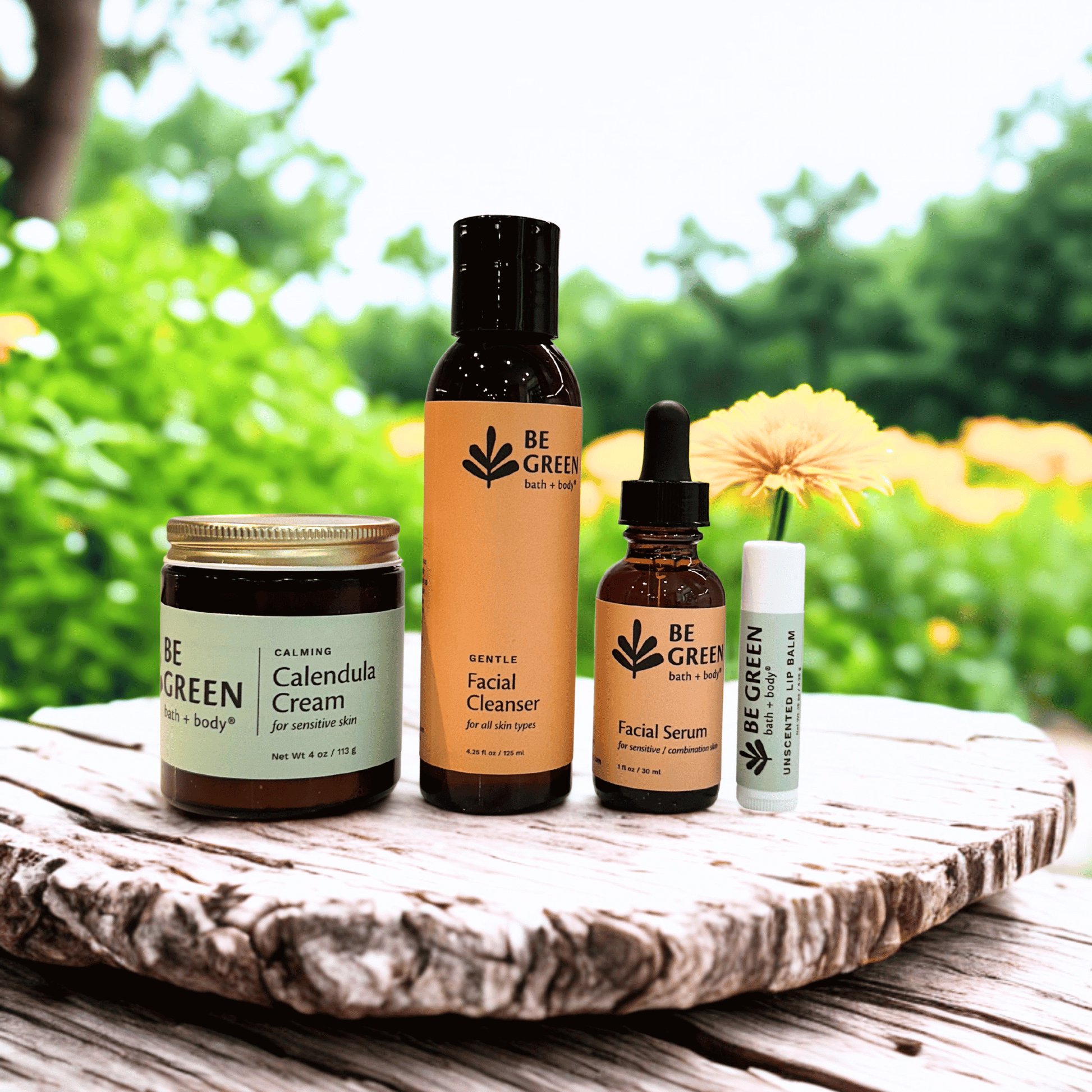 Collection of 'Be Green' skincare products on a wooden surface with a natural background. Non-toxic products for sensitive skin.