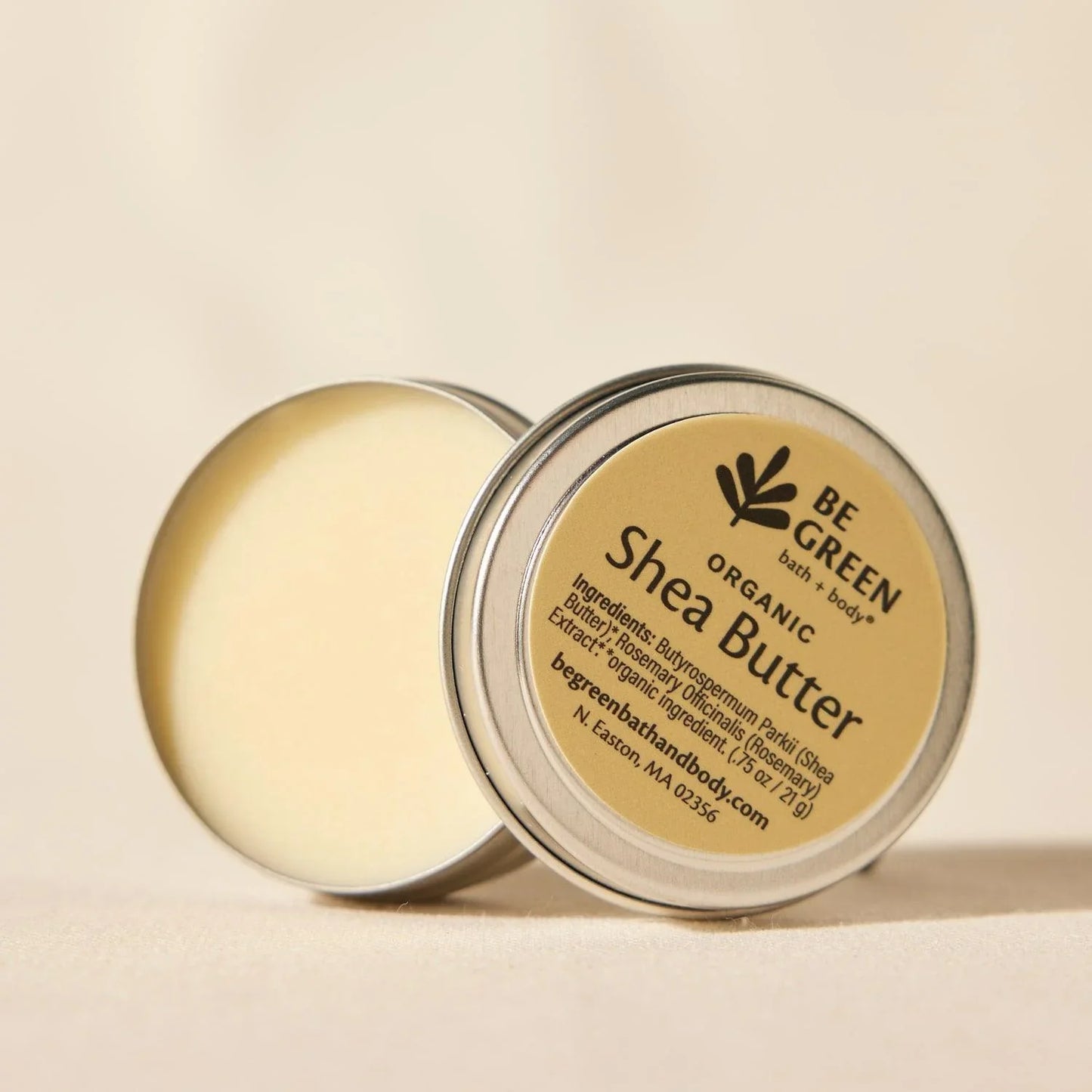 Open tin jar of organic unrefined shea butter.