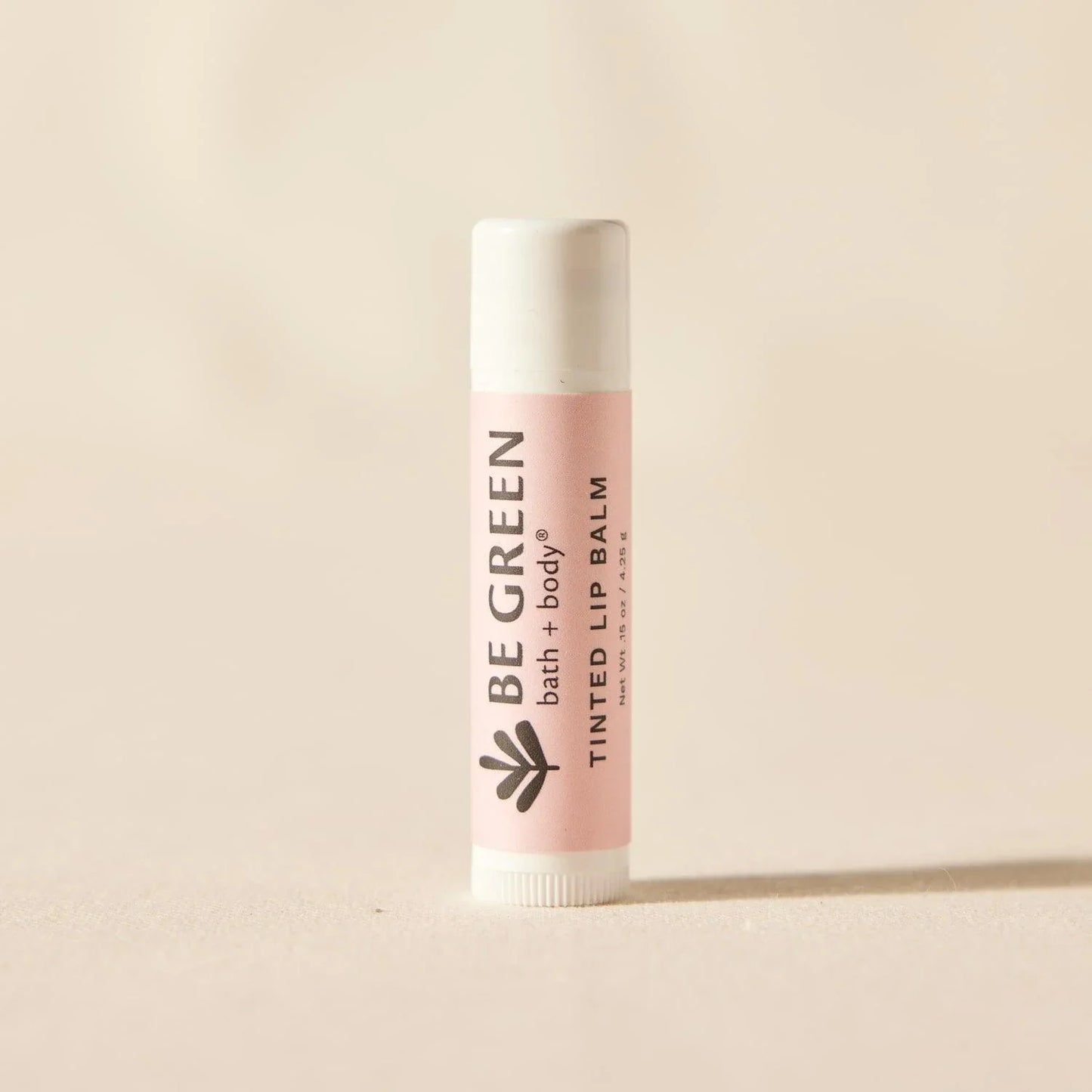 Organic tinted lip balm with cap on.  EWG Verified.
