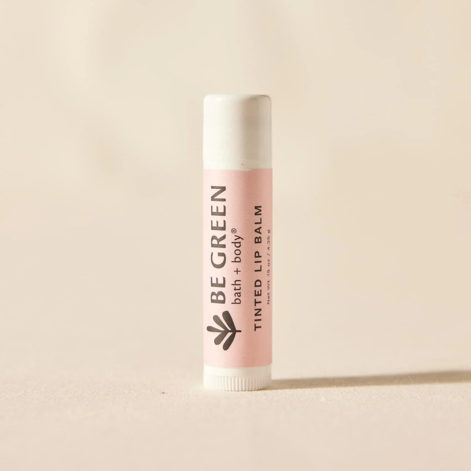 Organic tinted lip balm with cap on.  EWG Verified.