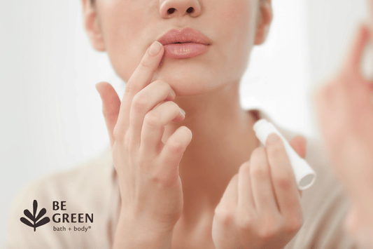 Woman applying lip balm to dry lips