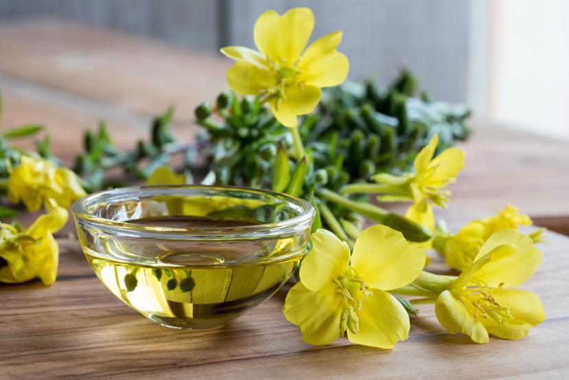 Evening Primrose Soothing Oil in a bowl with flowers