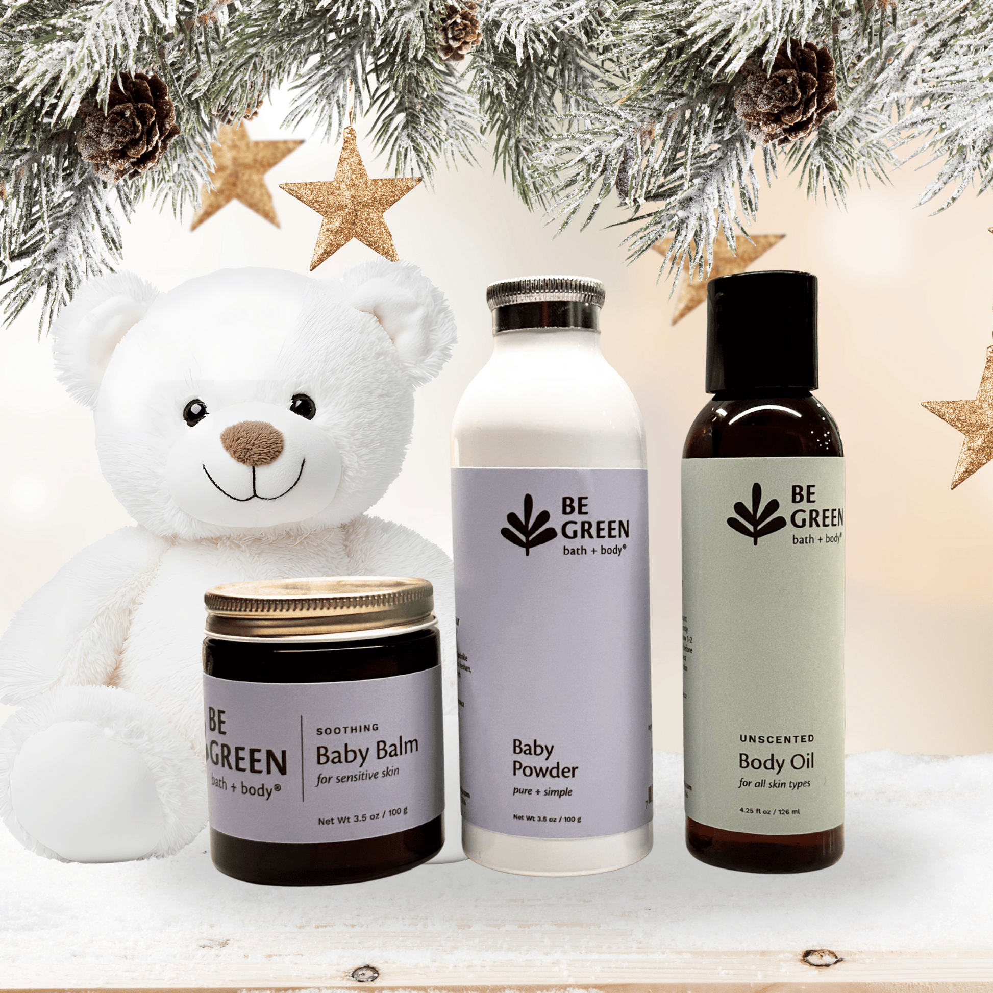 Be Green baby and body care products with a teddy bear and Christmas decorations.
