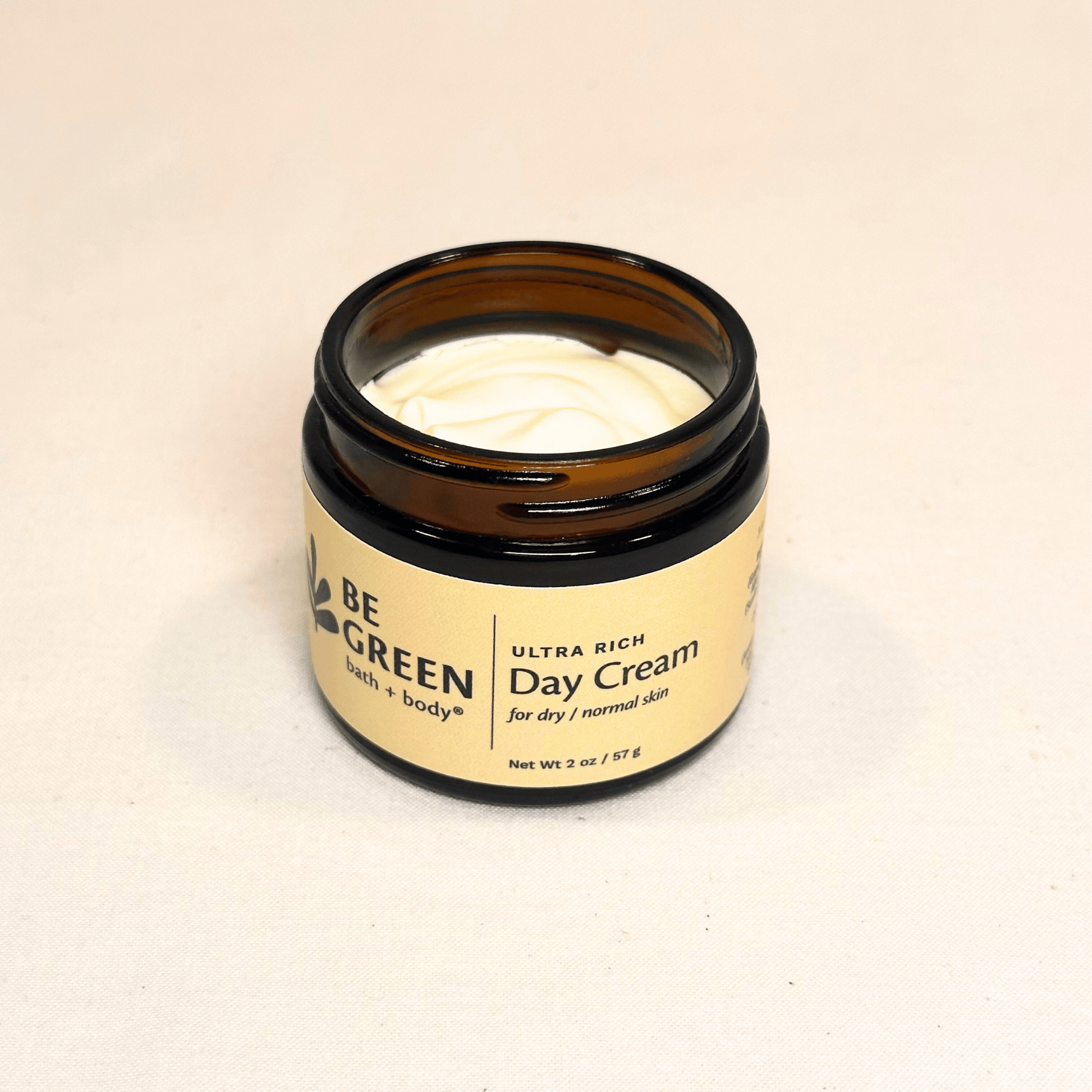 Ultra rich day cream open jar in amber glass