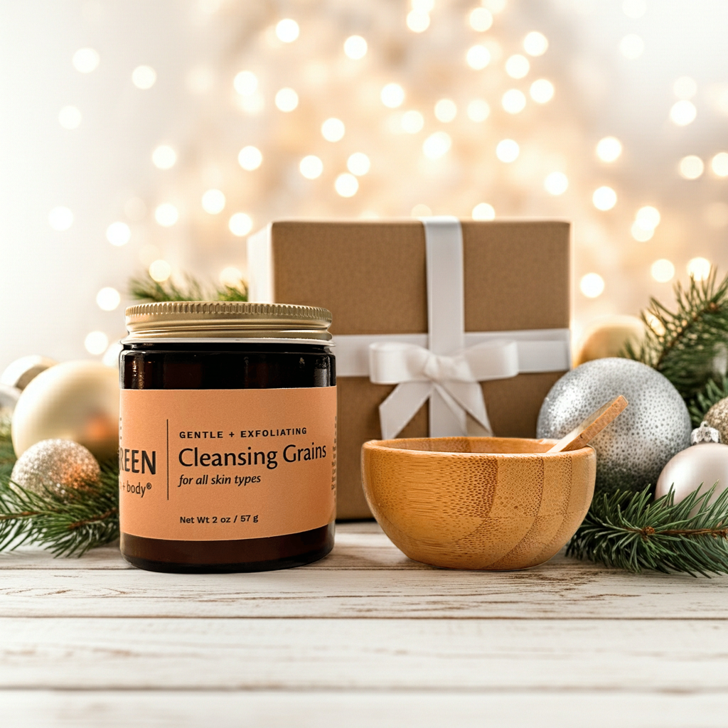 Jar of 'GENTLE + EXFOLIATING Cleansing Grains' with a wooden bowl and festive background