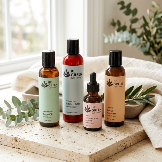 Four BE GREEN EWG Verified skin care products arranged on a stone tray with a neutral fabric and eucalyptus leaves in front of a softly lit window.