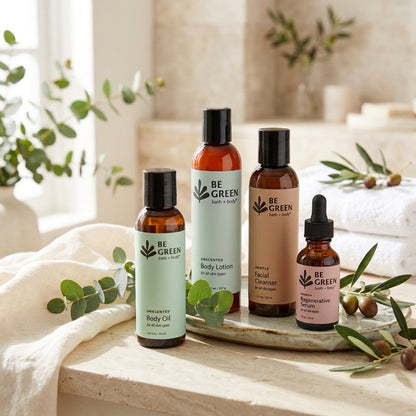 Four skincare products on a light stone with towels