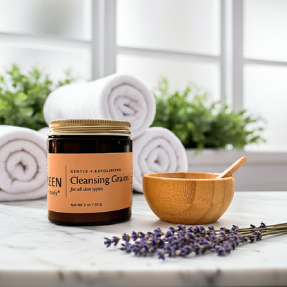 Jar of cleansing grains with a wooden bowl and lavender on a marble surface.
