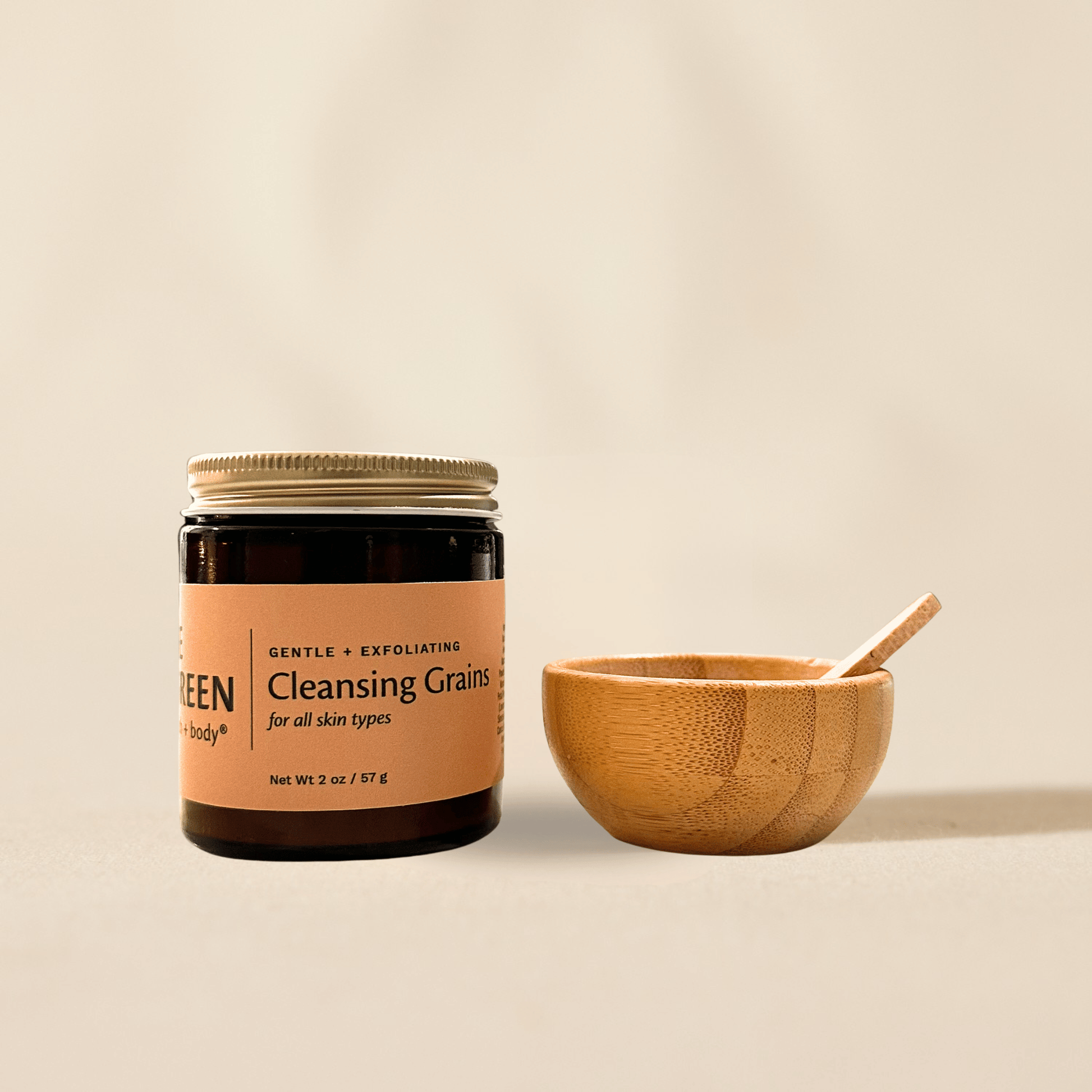 Jar of 'Cleansing Grains' with a wooden bowl and spoon on a beige background