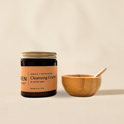 Jar of 'Cleansing Grains' with a wooden bowl and spoon on a beige background