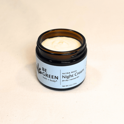 Natural night cream for dry and normal skin in an open amber glass jar