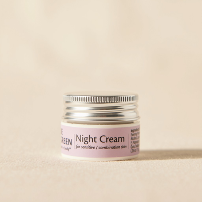 A trial size jar of Night Cream for sensitive skin with a silver metal lid and a light pink label, set against a warm beige background.
