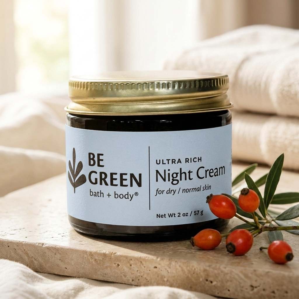 A jar of BE GREEN bath and body Ultra Rich Night Cream sits on a stone slab with dried rose hips and soft neutral fabric in the background.