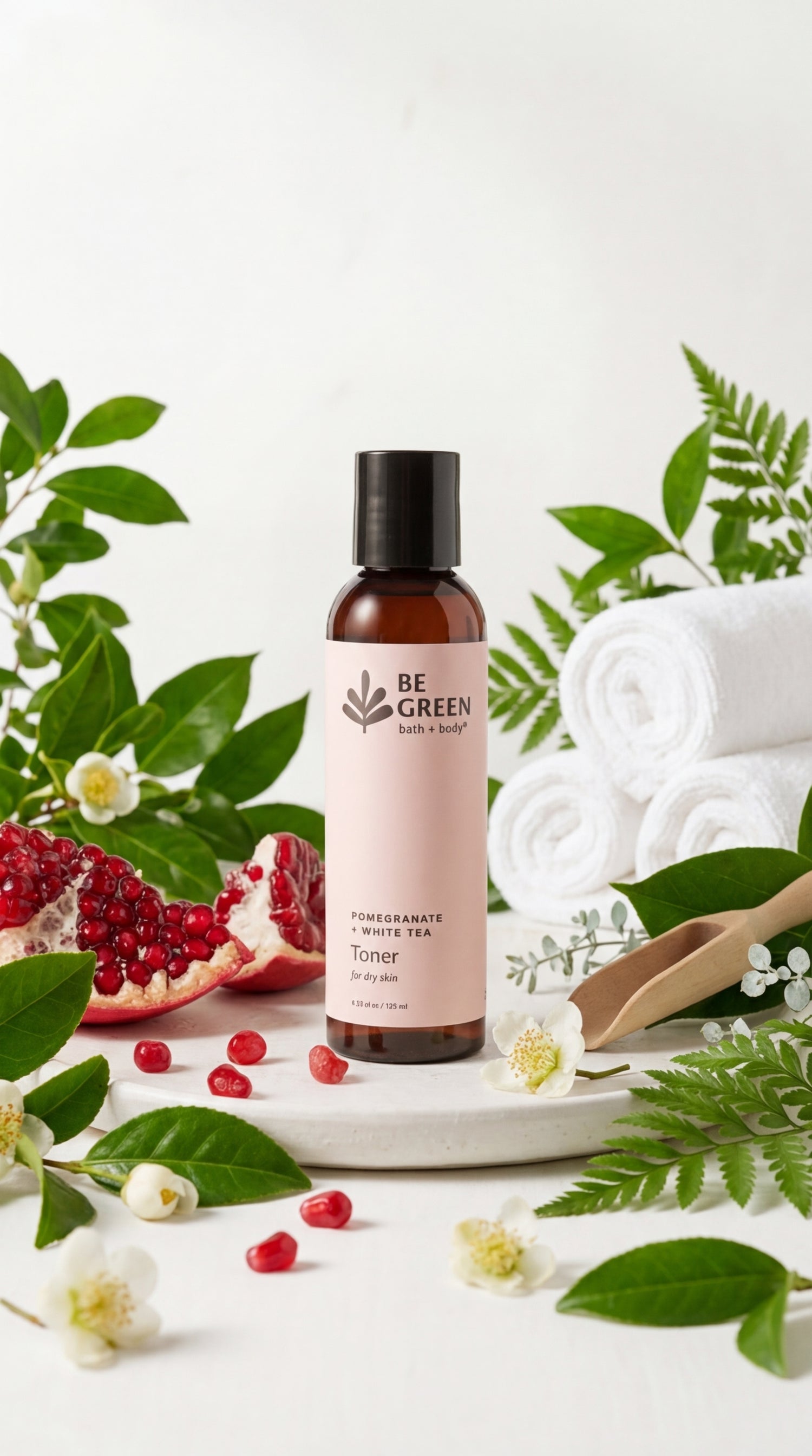 Be Green skincare bottle with pomegranate and leaves on a white background