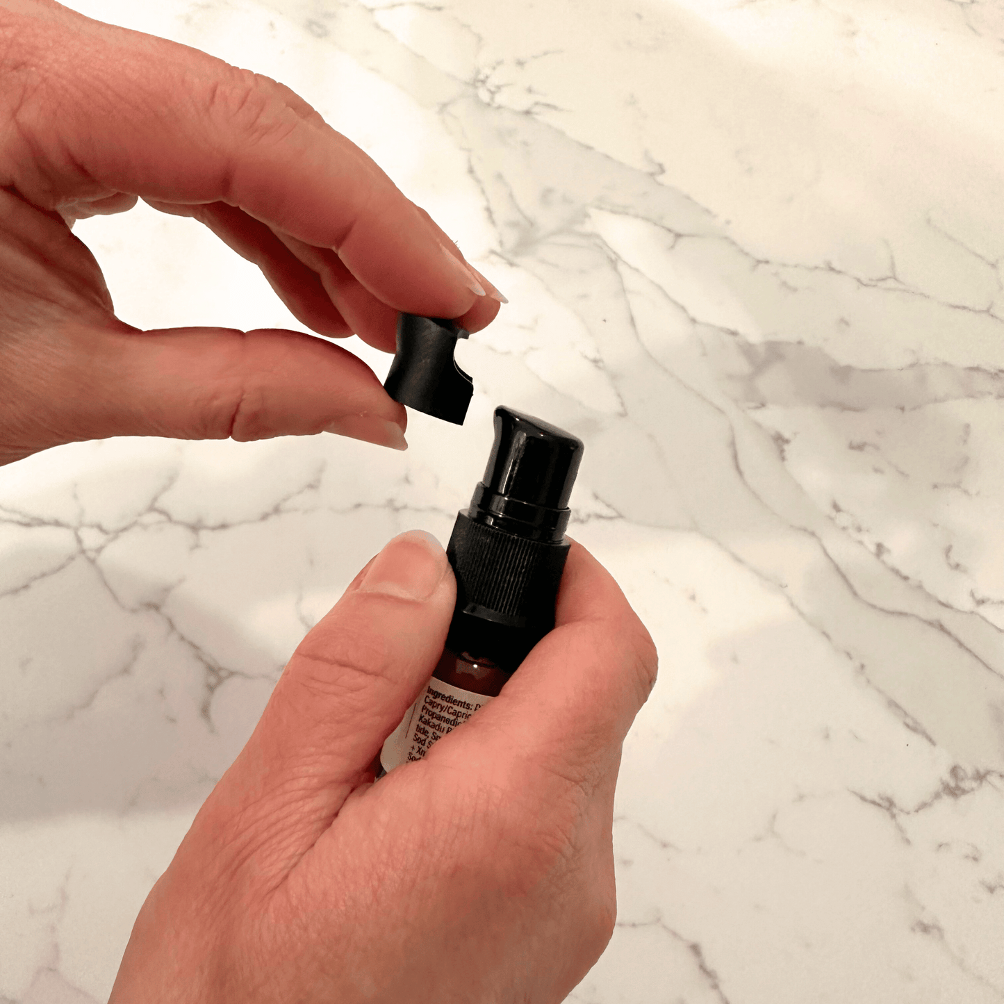 Removing the overcap on the trial size RevitaLuxe Radiance Serum