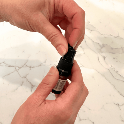 Removing the overcap on the trial size RevitaLuxe Radiance Serum