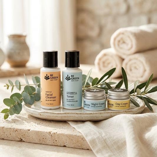 Four skincare products from Be Green Beauty Shop arranged on a ceramic tray with eucalyptus leaves, set on a stone surface with rolled towels in the background.